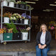 sitting on step next to buckets of flowers